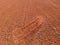 Detail with a sport shoe footprint on a tennis clay court