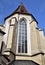 Detail with stained glass window, in the blue sky, of a church in Graz.