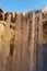 Detail of stalagmites and water falling from the Skógafoss waterfall in Iceland illuminated by late afternoon sunlight