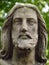 Detail of statue - Christus face on grave in old abadoned cemetary