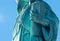 Detail of Statue of Liberty against blue sky, book with the date of USA\\\'s independence. New York City, United States