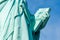 Detail of Statue of Liberty against blue sky, book with the date of USA\\\'s independence. New York City, United States