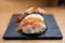 Detail of steamed prawn nigiri, with background of nigiri with Pacific Sea Urchin, steamed salmon, steamed shrimp, caviar, roasted