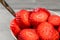 Detail on strawberries cut in circles, in white ceramic bowl wit