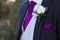 Detail of a suit of groom with a white rose
