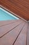 Detail of swimming pool coping and cover constructed by cumaru wood deck, horizontal and vertical hardwood decking texture