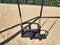 Detail of swing bench with metal ropes on sand ground of playground. Closeup of empty swing on children playground. Children swing