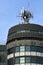 Detail of the telecommunication tower on the roof of a palace with the blue sky. Telecommunication tower with antennas and