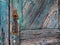 Detail of Textured Old Blue Painted Wooden Door