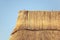 Detail of a thatched roof house using reed grass as building material.