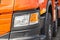 Detail of a truck. A fragment of a large commercial semi truck with modern design of headlights