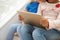 Detail Of Two Girls Sitting On Stairs Using Digital Tablet