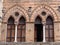 Detail of Two Windows in a Building with Exposed Bricks in the Medieval Tuscan Town of San Gimignano - Italy