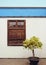 Detail of a typical facade of a small house with window and a plant in Garachico, Tenerife,