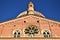 Detail of the upper part of the facade of the Basilica of Sant`Antonio in Padua with a large rose window and blue sky.