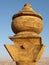 Detail of the vertical view of the upper adornment of the facade of the Monastery with the mountain in the background in Petra, Jo