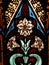 Detail of Victorian stained glass window showing white flower and decorative detail