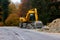 Detail view of a big excavator used to destroy old asphalt road on a mountain road.