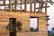 Detail view, corner of new wooden ecological traditional cottage of natural lumber materials with steep roof frame under construct