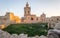 Detail view on the old, historical St. Joseph`s Chapel inside the Citadel of Victoria inside antique ruins walls with grass field