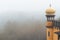 Detail view of a yellow dome column at Pena Palace Palacio da Pena fully engulfed in fog with poor views of the nearby forest