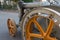 Detail of Vintage Agricultural Tractor with Yellow Metallic Whee