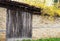 Detail of vintage wooden door, stone wall