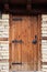Detail of vintage wooden door, stone wall