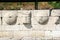 Detail of a wall of shields and torsos along the main road Dion