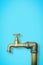 Detail of a water brass faucet  on solid color background - image with copy space