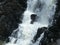 Detail of a waterfall, the water crashes down the rocks