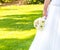 Detail of wedding bouquet of flowers in hand of a bride in a garden