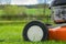 Detail of wheel and piece of motor of lawn mower (grass cutter)