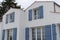 Detail of a white house with blue gray shutters and door in Noirmoutier in vendÃ©e France