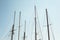 Detail of white masts of a boat with blue sky at the background