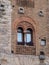 Detail of a Window in a Building with Exposed Bricks in the Medieval Tuscan Town of San Gimignano - Italy