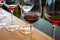 Detail of wine glasses with red wine on wood counter