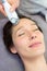 Detail of a woman face receiving a facial massage treatment