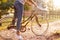 Detail Of Woman Riding Bike Along Country Lane At Sunset