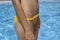 A Detail of a woman`s belly near the pool
