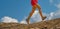 Detail of woman& x27;s legs walking athlete in mountain