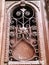 Detail of wooden door of a building on the street with an iron decorative ornament. Old Tbilisi architecture