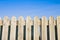 Detail of a wooden fence built with spiky wooden boards against