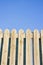 Detail of a wooden fence built with spiky wooden boards against