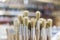 Detail of wooden paint brushes in store with great blur