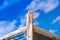 Detail of a wooden shipwreck with cloudy blue sky background.