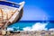 Detail of a wooden shipwreck with turquoise tropical sea background.