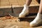 Detail of a young girl`s white shoes on a skateboard in the foreground