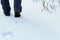 Detail of young man, hiker shoe steps in clear snow