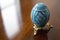 Detailed Blue Pysanky Ukrainian Easter Egg on a Wooden Table